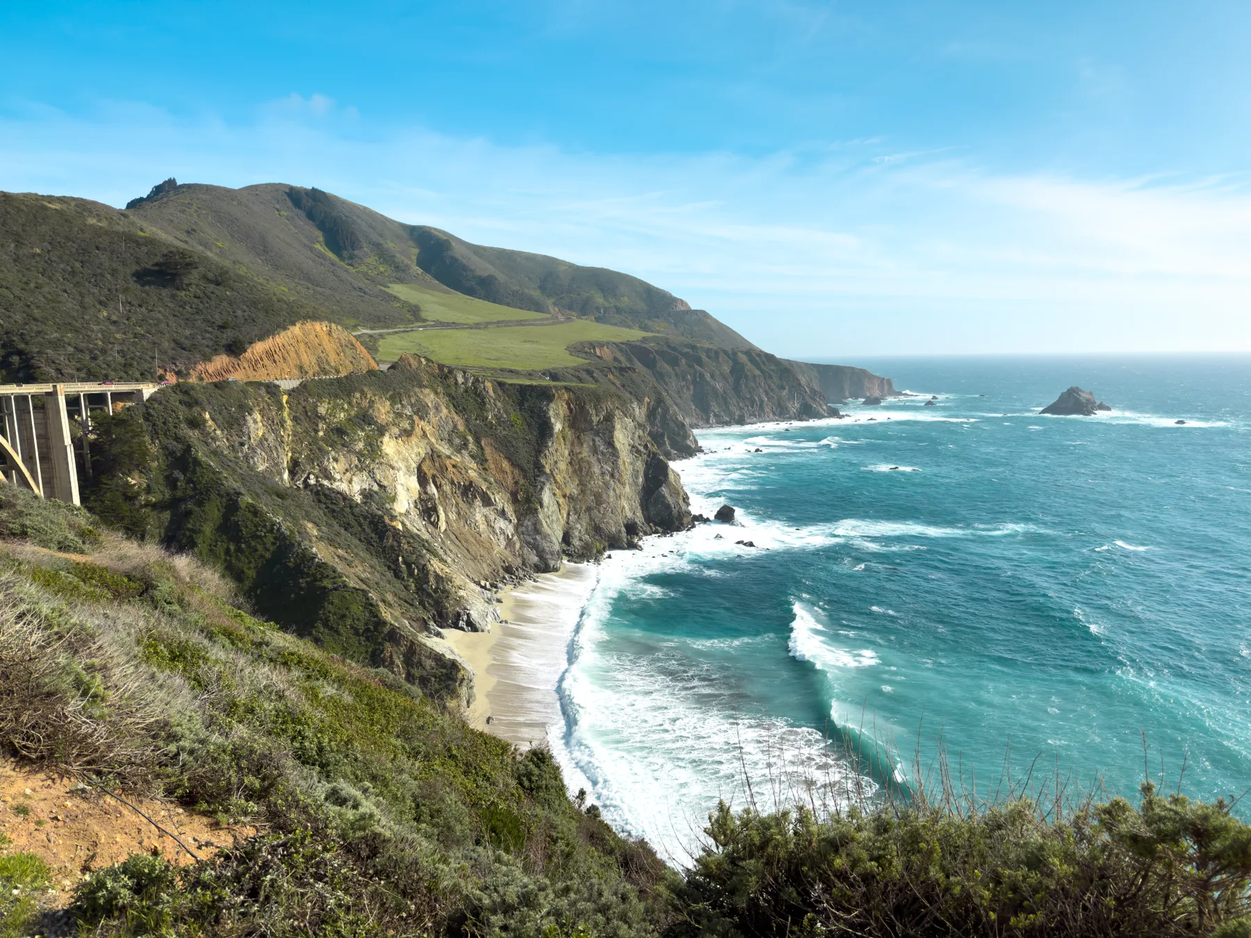 Rugged coastline with a bridge along the cliffs